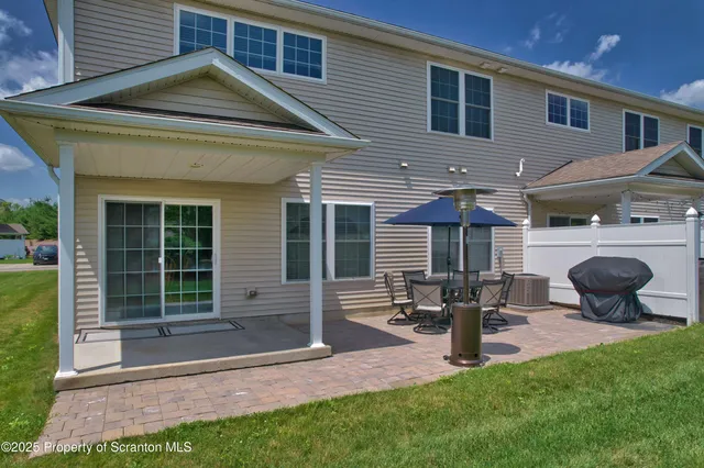 an aerial view of a house with backyard space and balcony