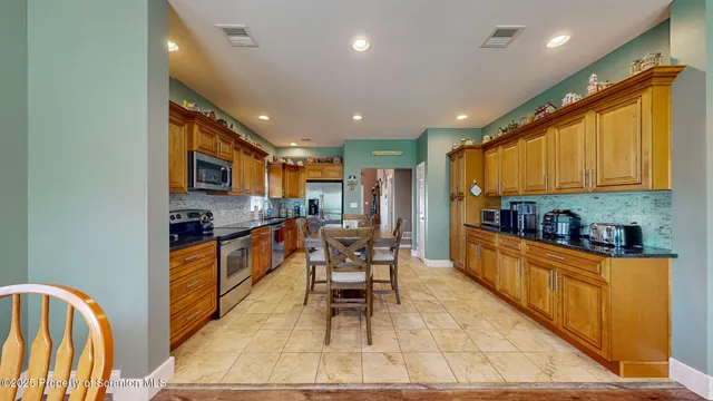 a dining room with furniture a chandelier and wooden floor