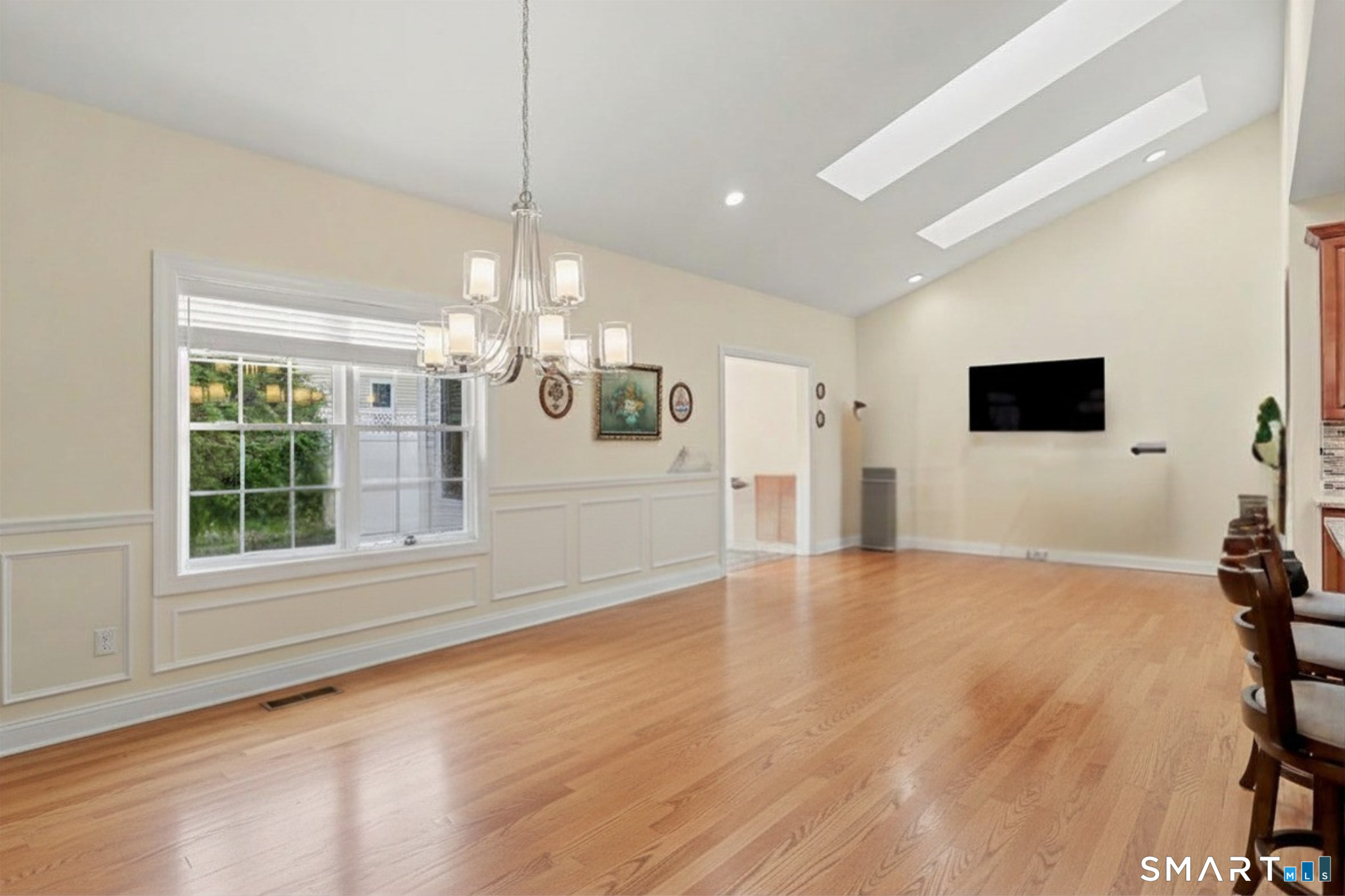 223 Meadow Brook Road, Unit 223 Oxford, CT 06478 - Photo 8 of 34 a view of an empty room with a window and wooden floor