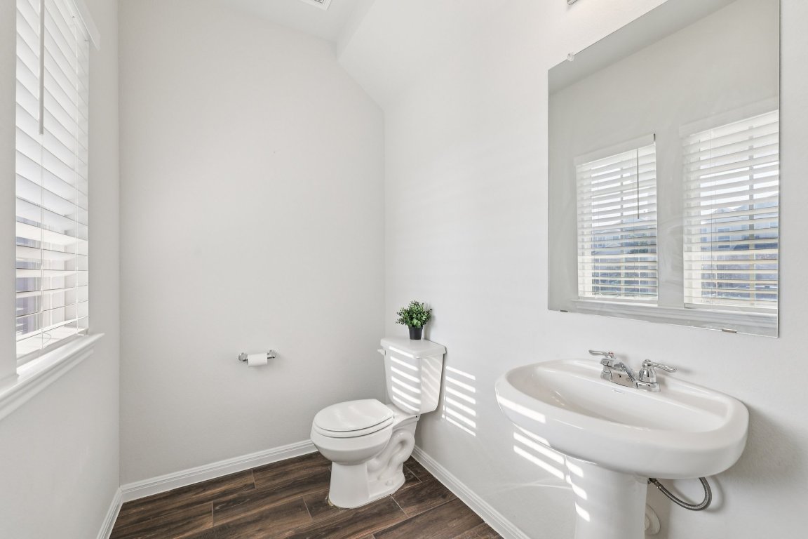 10712 Blacket Drive Austin, TX 78747 - Photo 16 of 40 a bathroom with a sink toilet and a window