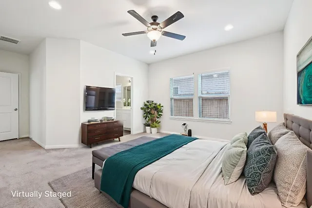 a bedroom with a large bed and a flat screen tv