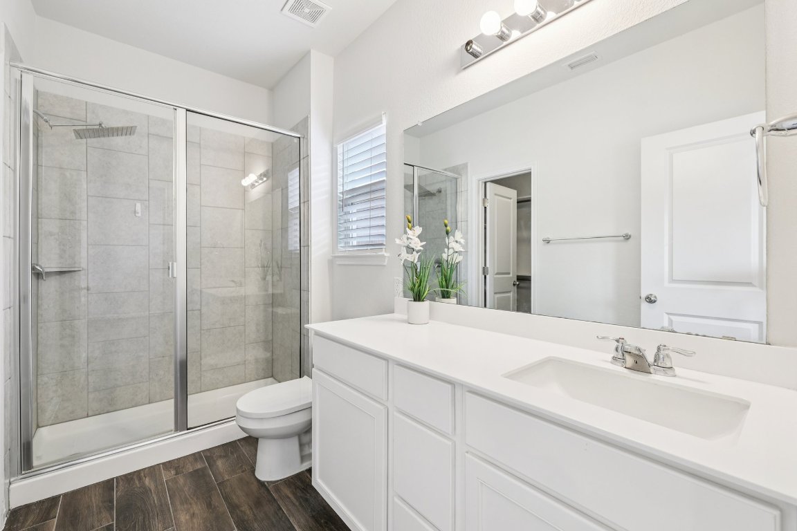 10712 Blacket Drive Austin, TX 78747 - Photo 21 of 40 a bathroom with a sink toilet and shower