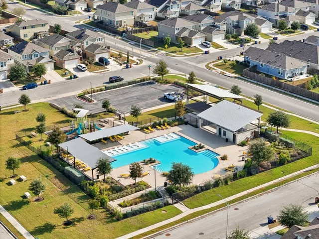 an aerial view of residential houses with outdoor space