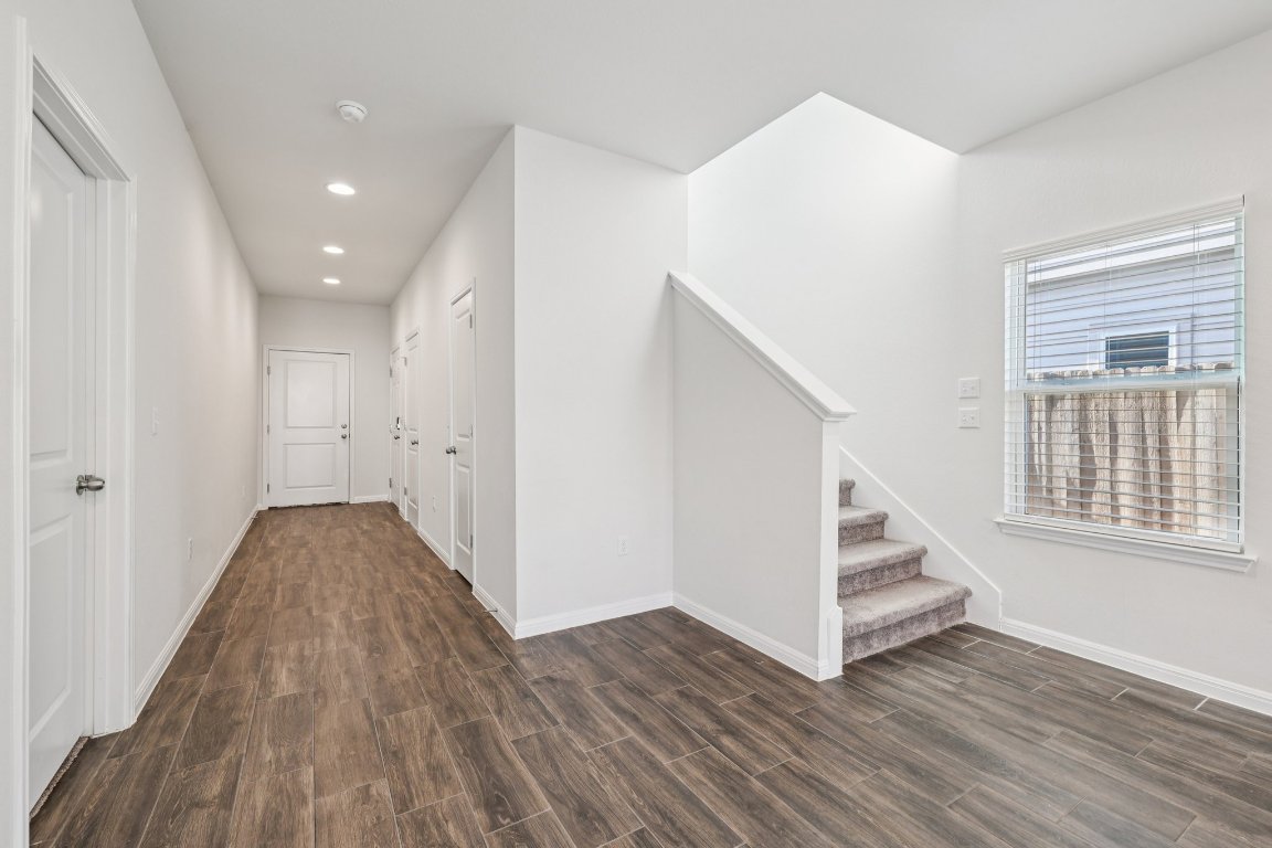 10712 Blacket Drive Austin, TX 78747 - Photo 5 of 40 a view of a livingroom with wooden floor and stairs