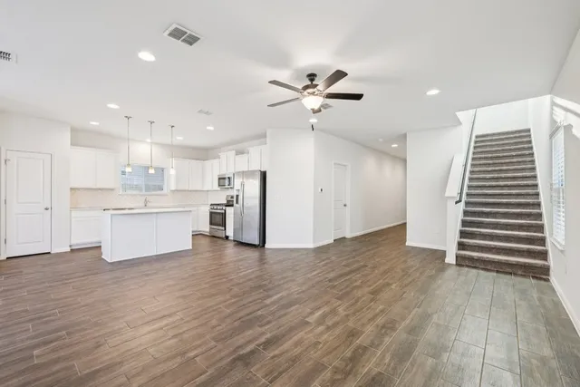 a view of kitchen with wooden floor and electronic appliances