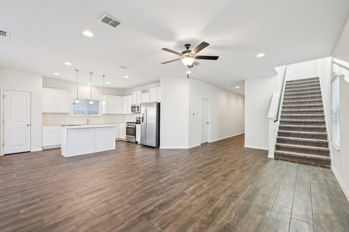 10712 Blacket Drive Austin, TX 78747 - Photo 6 of 40 a view of kitchen with wooden floor and electronic appliances