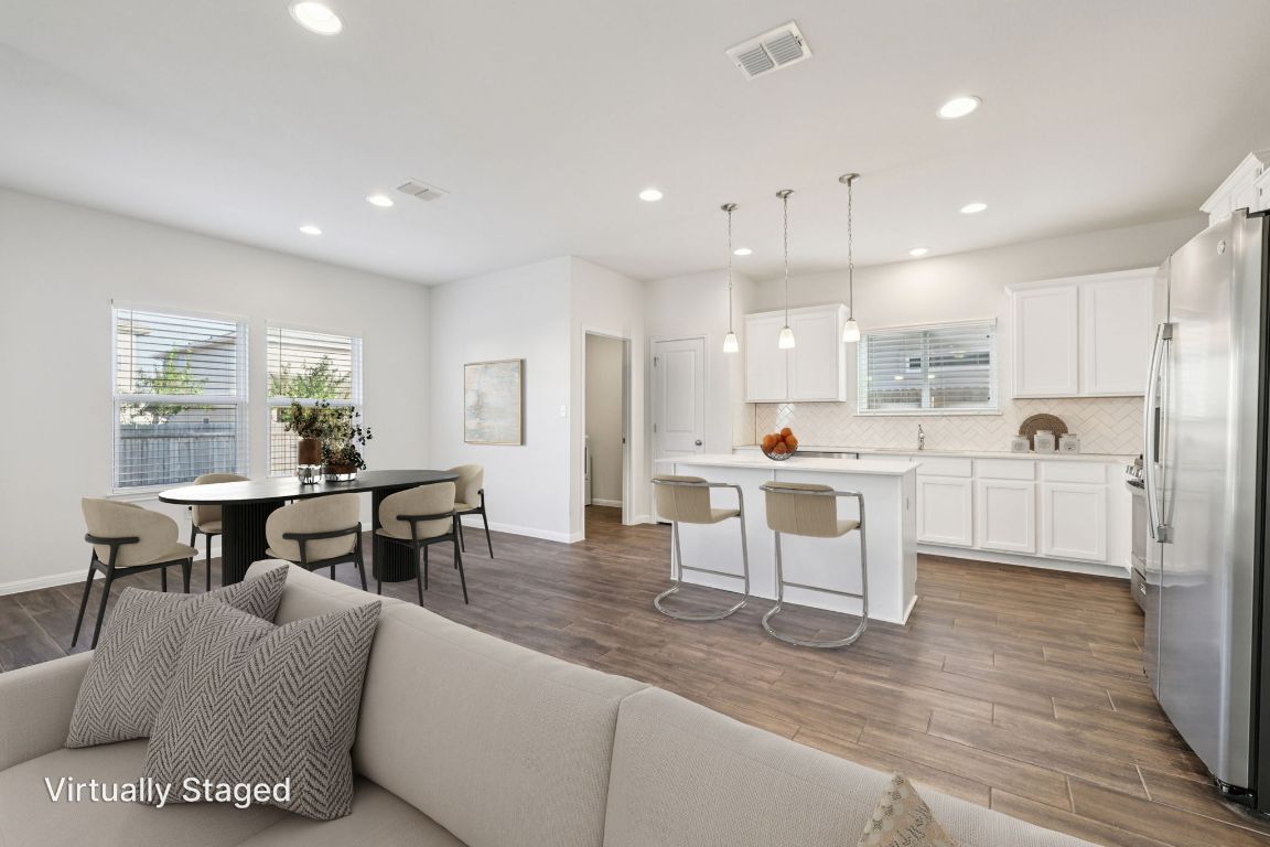 10712 Blacket Drive Austin, TX 78747 - Photo 7 of 40 a living room with stainless steel appliances kitchen island granite countertop furniture and a dining table with kitchen view