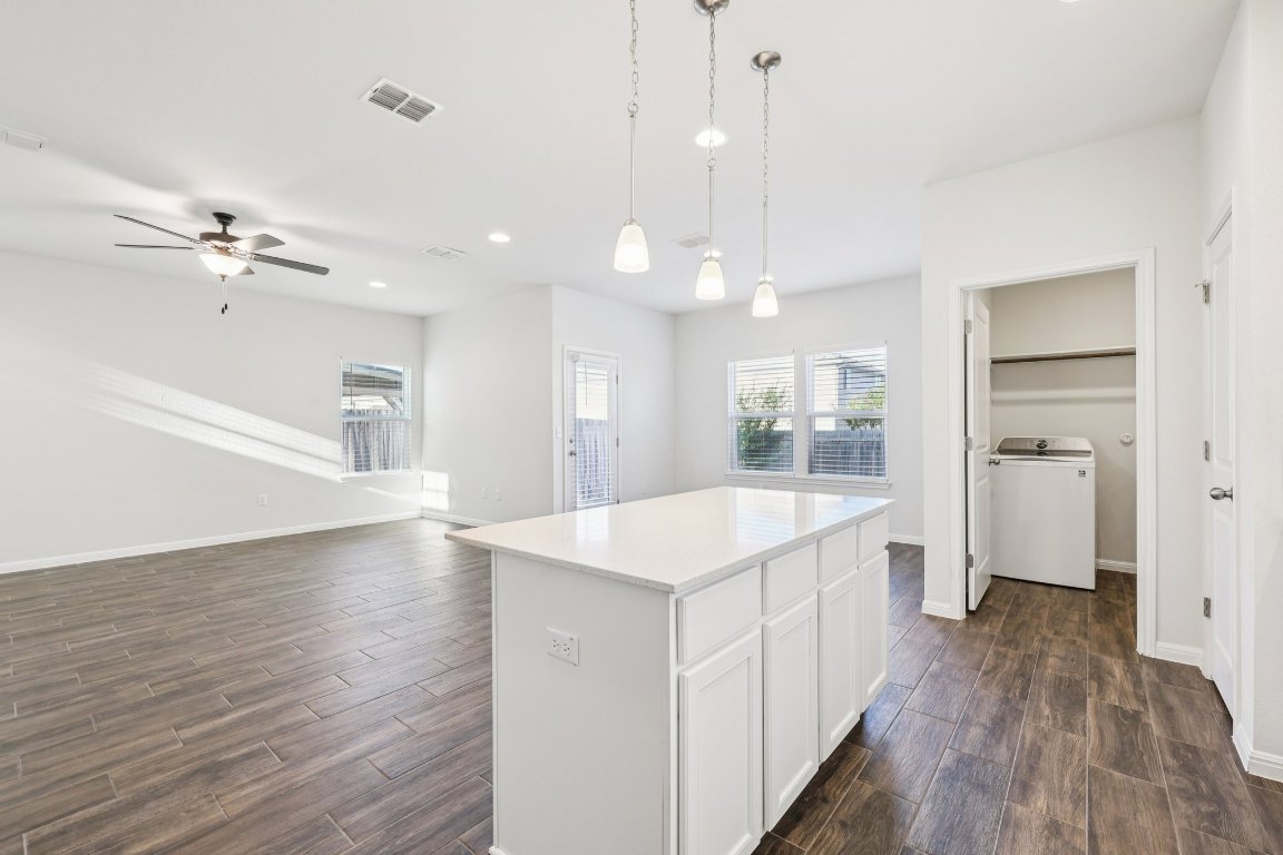 10712 Blacket Drive Austin, TX 78747 - Photo 10 of 40 a kitchen with a sink and wooden floor