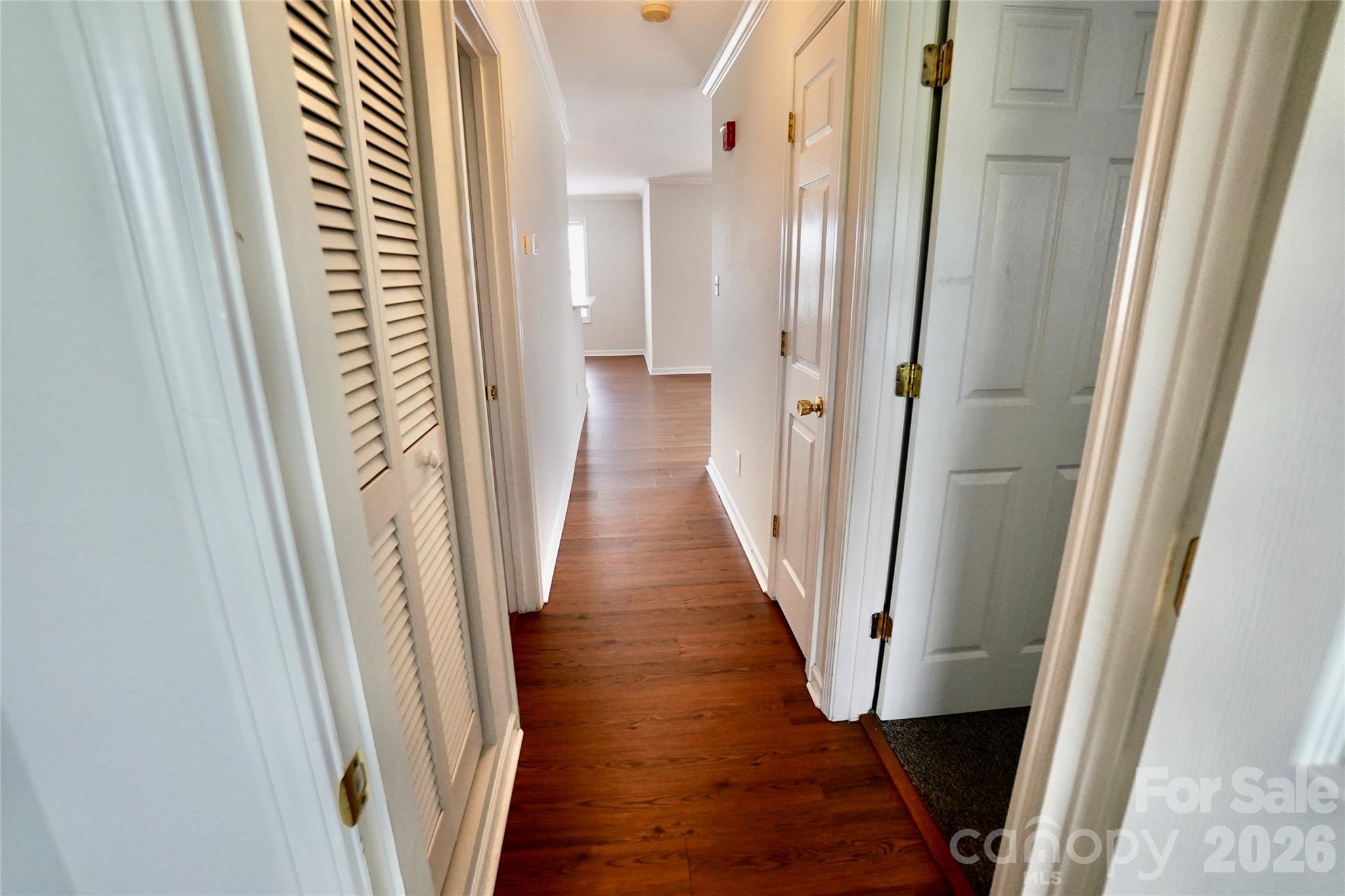 4010 Town Center Road Harrisburg, NC 28075 - Photo 11 of 17 a view of a hallway with wooden floor and staircase