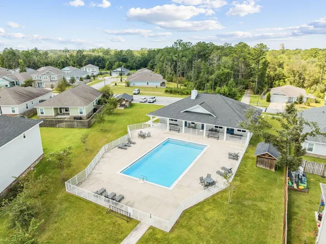 a view of a swimming pool with a yard and mountain view