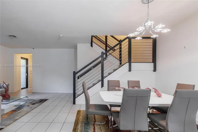 a living room with furniture and a view of kitchen
