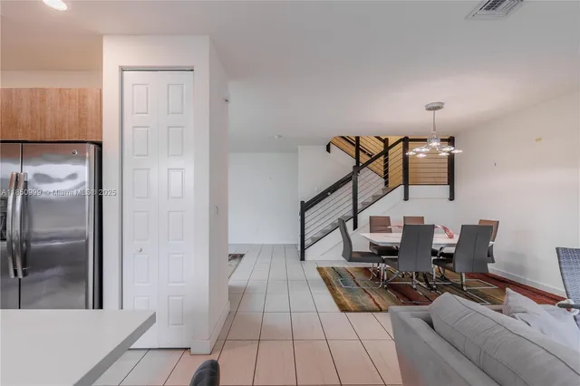 a kitchen with a sink refrigerator and cabinets
