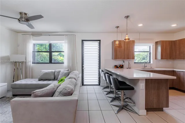 a kitchen with stainless steel appliances a stove a sink a microwave a refrigerator and cabinets