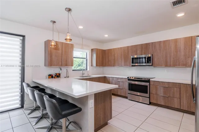 a kitchen with a refrigerator stove and microwave