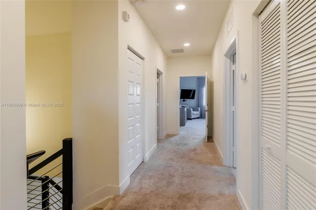 a bathroom with a granite countertop sink mirror vanity and toilet