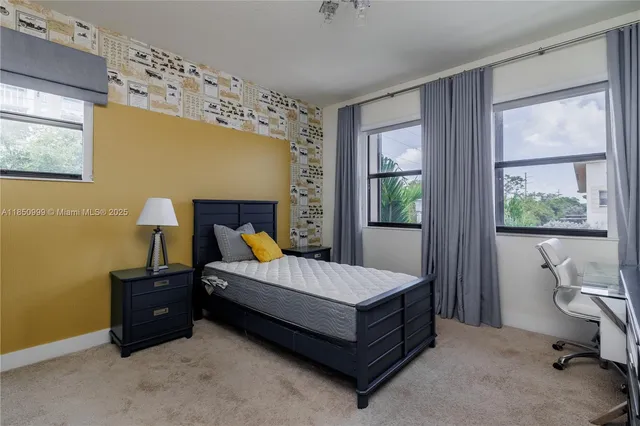 a bedroom with a bed and a couch