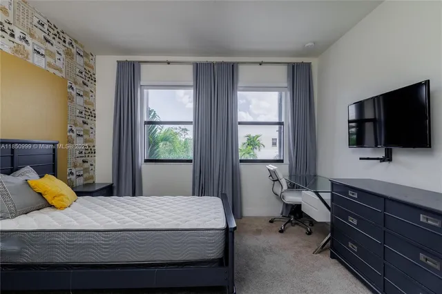 a spacious bedroom with a bed and a dresser in it