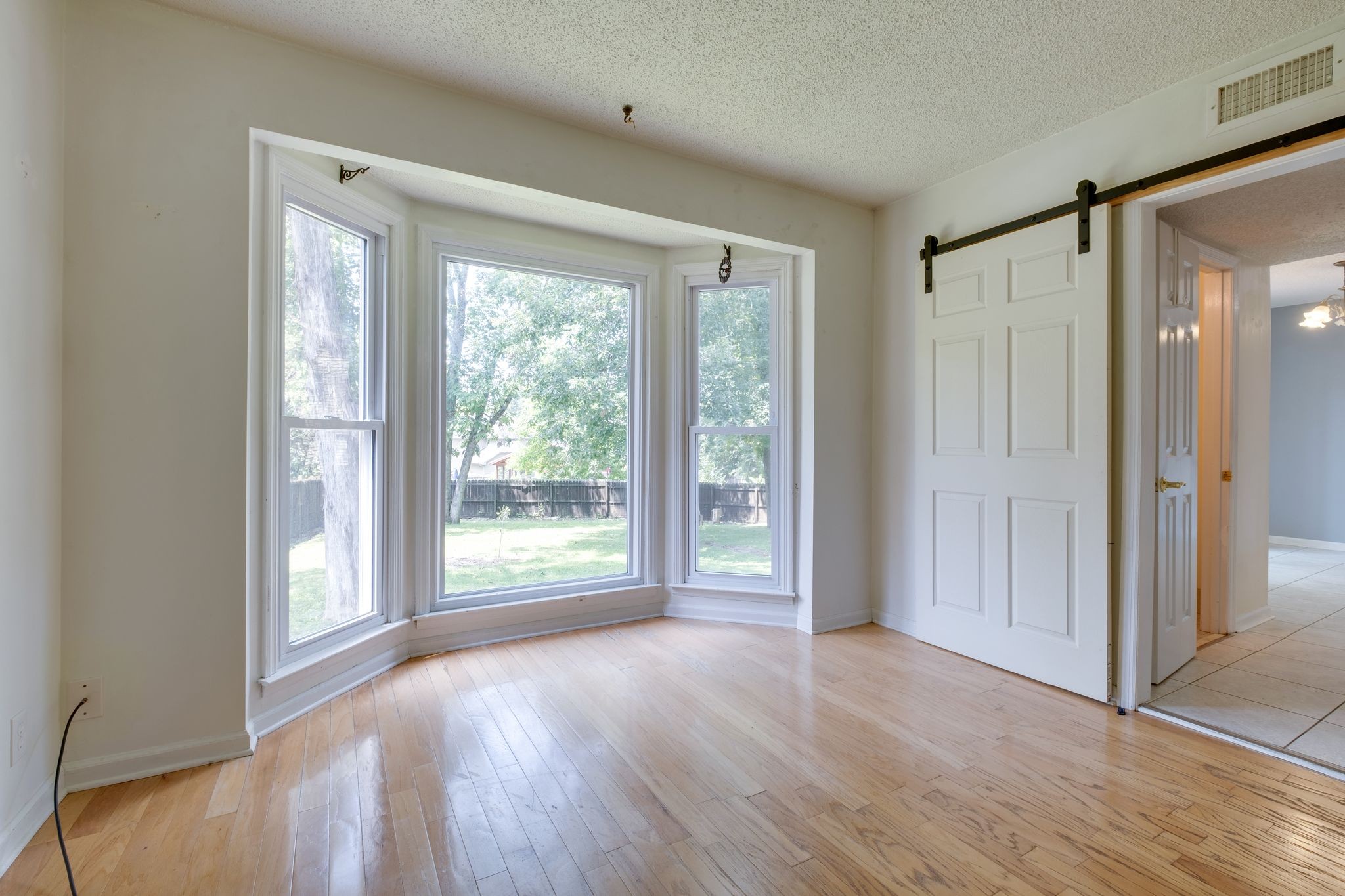 2445 Nonaville Road Mount Juliet, TN 37122 - Photo 11 of 29 a view of a big room with wooden floor and windows