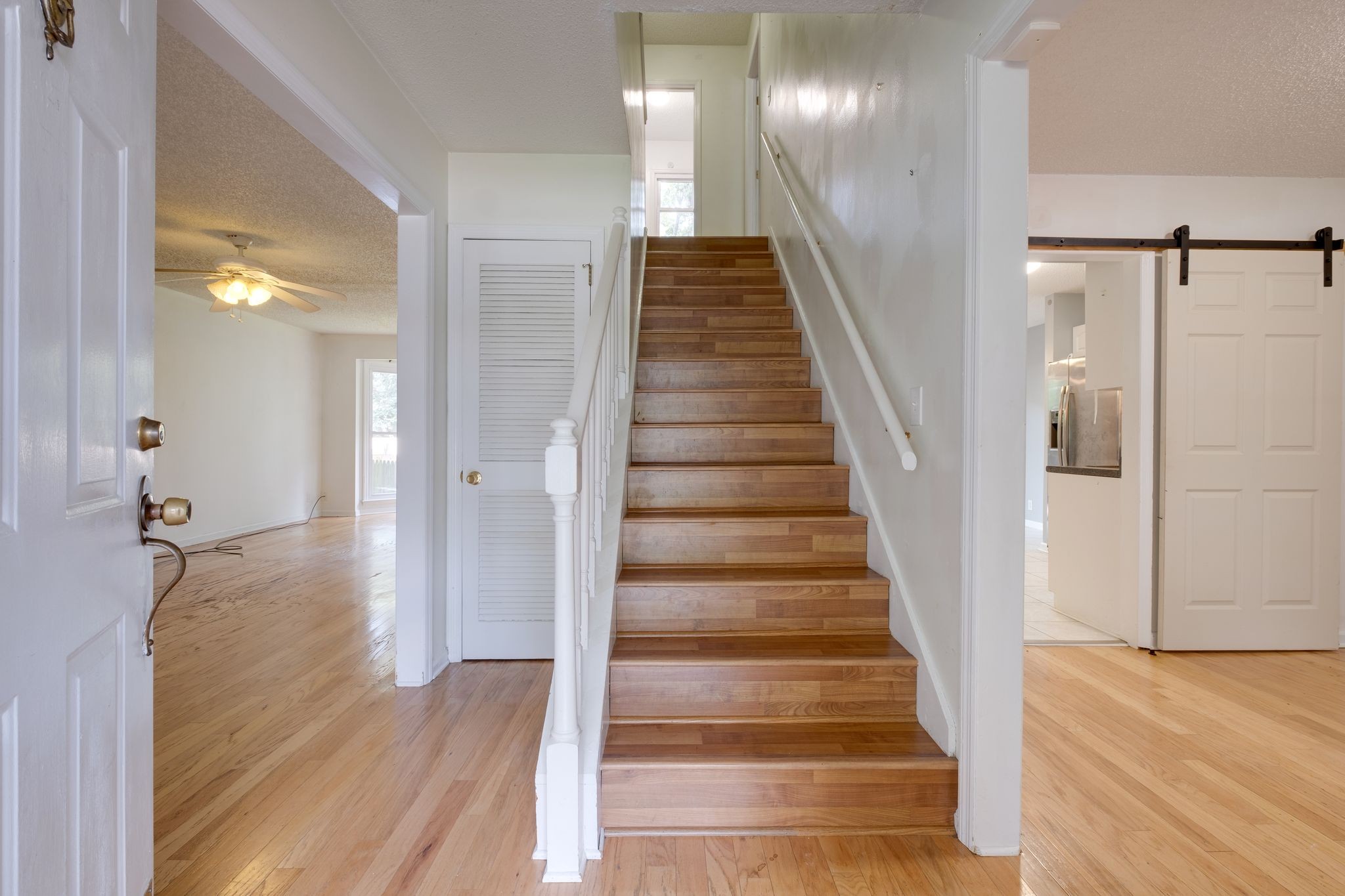 2445 Nonaville Road Mount Juliet, TN 37122 - Photo 7 of 29 a view of a hallway with wooden floor and staircase