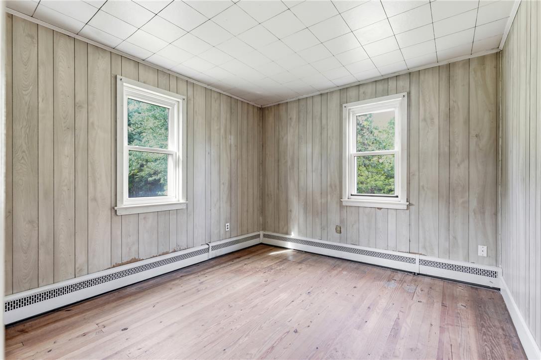 1033 Walt Road Pennsburg, PA 18073 - Photo 21 of 40 Rustic wood paneling and original hardwood floors define this versatile space.