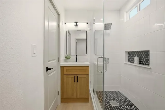 a bathroom with a shower and a sink