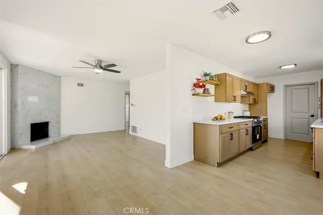 a view of a kitchen with fridge and workspace