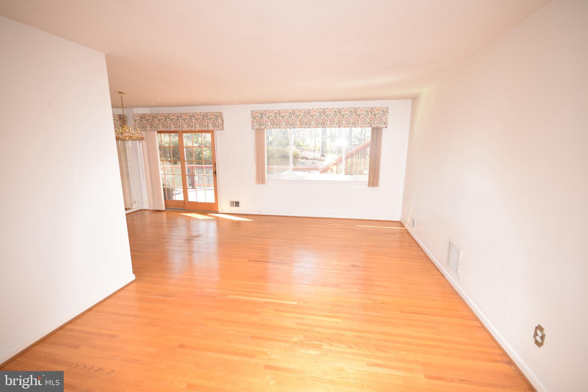 7004 Redmiles Road Laurel, MD 20707 - Photo 11 of 35 Living and dining rooms with hardwood flooring
