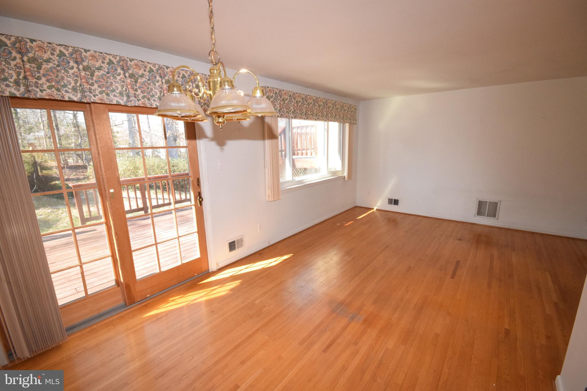 7004 Redmiles Road Laurel, MD 20707 - Photo 14 of 35 Living and dining rooms with hardwood flooring