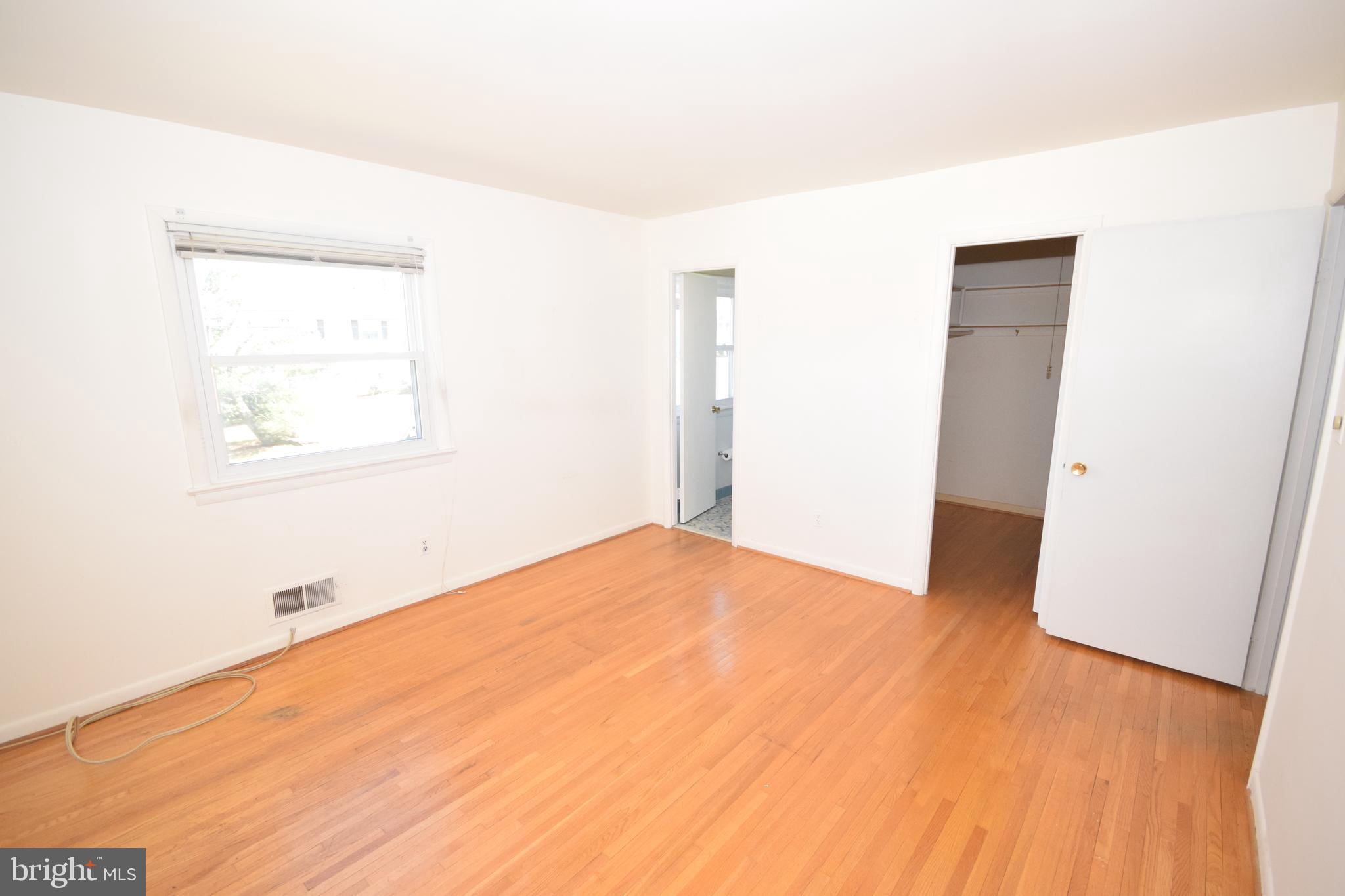 7004 Redmiles Road Laurel, MD 20707 - Photo 16 of 35 Master bedroom with hardwood floors and full bath