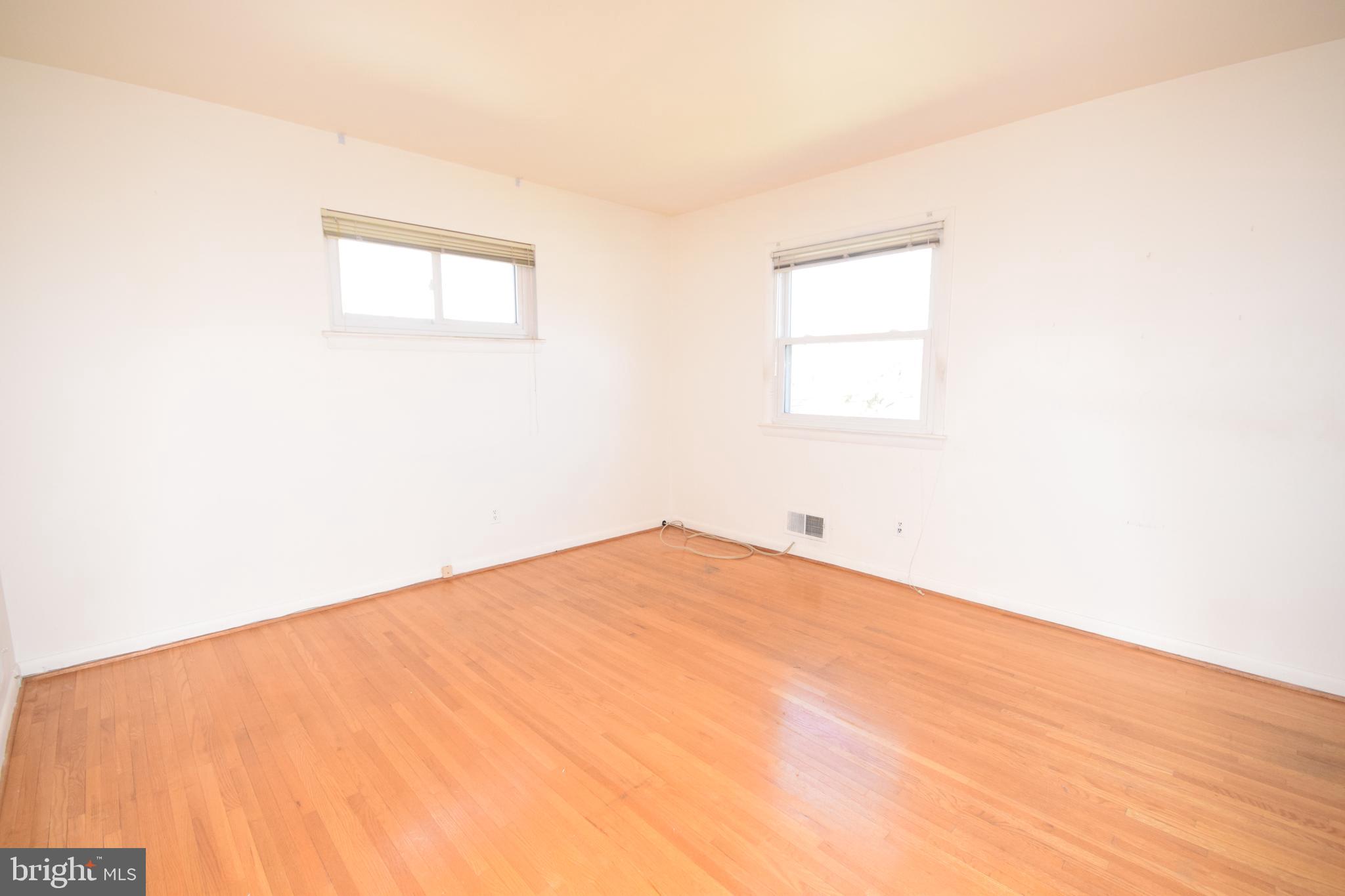 7004 Redmiles Road Laurel, MD 20707 - Photo 17 of 35 Master bedroom with hardwood floors and full bath
