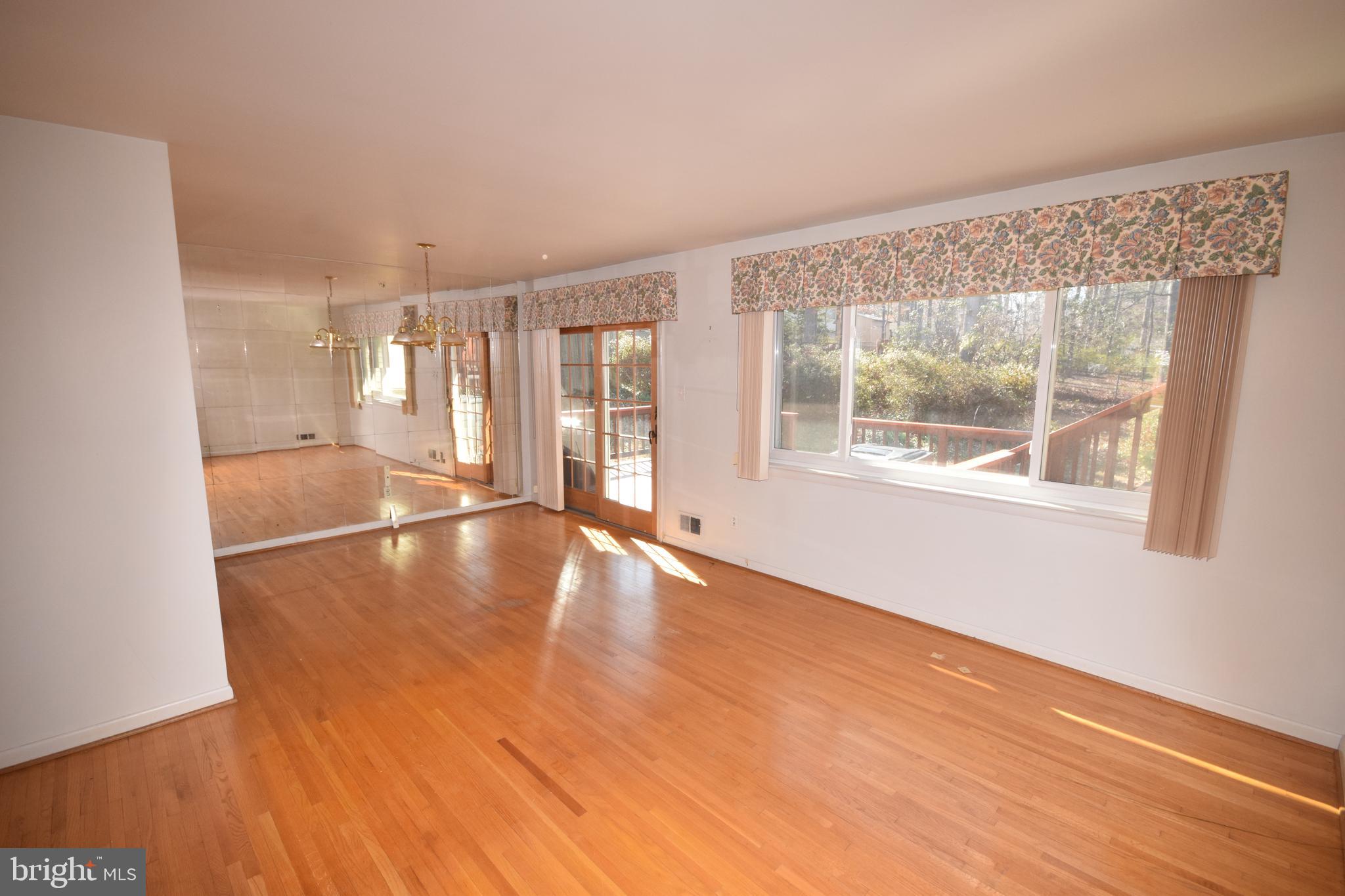 7004 Redmiles Road Laurel, MD 20707 - Photo 10 of 35 Living and dining rooms with hardwood flooring