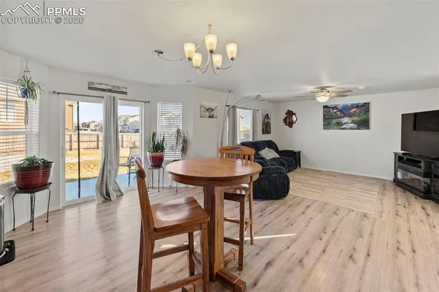 a view of a dining room with furniture and wooden floor