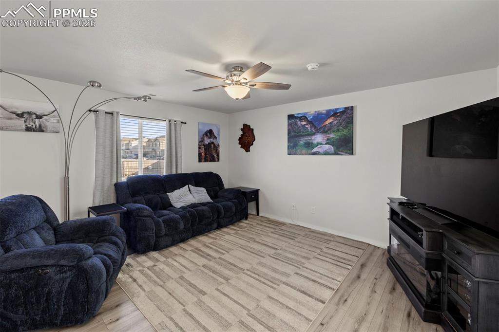 8151 Berwyn Loop Peyton, CO 80831 - Photo 13 of 39 a living room with furniture and a flat screen tv