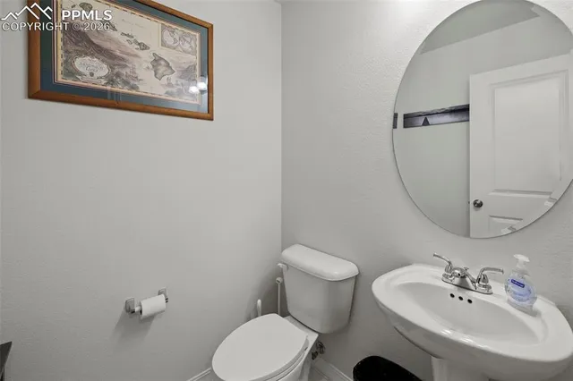a bathroom with a sink mirror and toilet