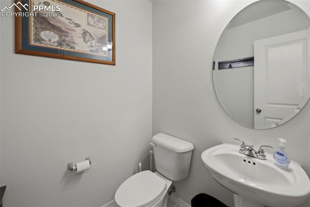 8151 Berwyn Loop Peyton, CO 80831 - Photo 15 of 39 a bathroom with a sink mirror and toilet