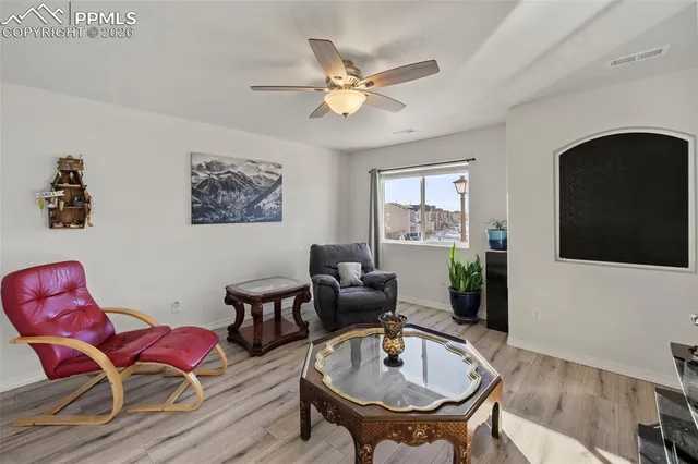 a living room with furniture a flat screen tv and a large window