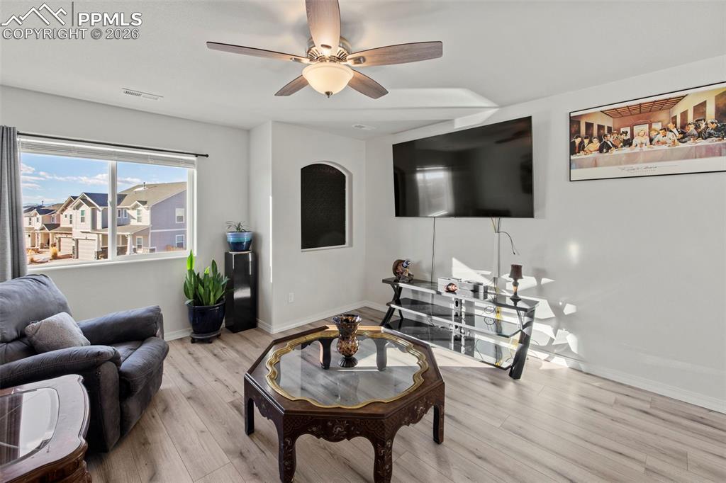 8151 Berwyn Loop Peyton, CO 80831 - Photo 20 of 39 a living room with furniture and a flat screen tv