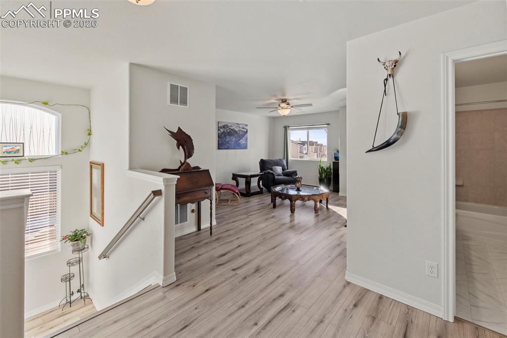 8151 Berwyn Loop Peyton, CO 80831 - Photo 21 of 39 a living room with furniture and a wooden floor