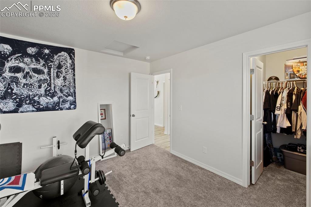 8151 Berwyn Loop Peyton, CO 80831 - Photo 28 of 39 a bedroom with a bed and a closet