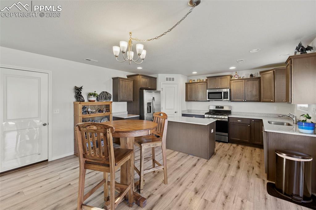 8151 Berwyn Loop Peyton, CO 80831 - Photo 10 of 39 a kitchen with a table chairs microwave and cabinets