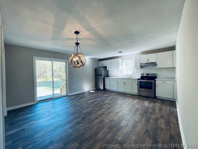 5881 Murphy Road Stedman, NC 28391 - Photo 17 of 22 a view of empty room with wooden floor and window