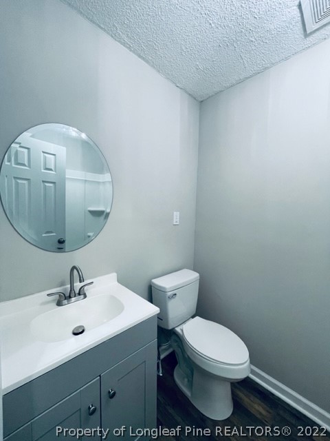 5881 Murphy Road Stedman, NC 28391 - Photo 8 of 22 a bathroom with a toilet a sink and mirror