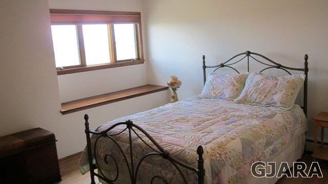 2380 K Road Grand Junction, CO 81505 - Photo 8 of 27 a bedroom with a bed and a window