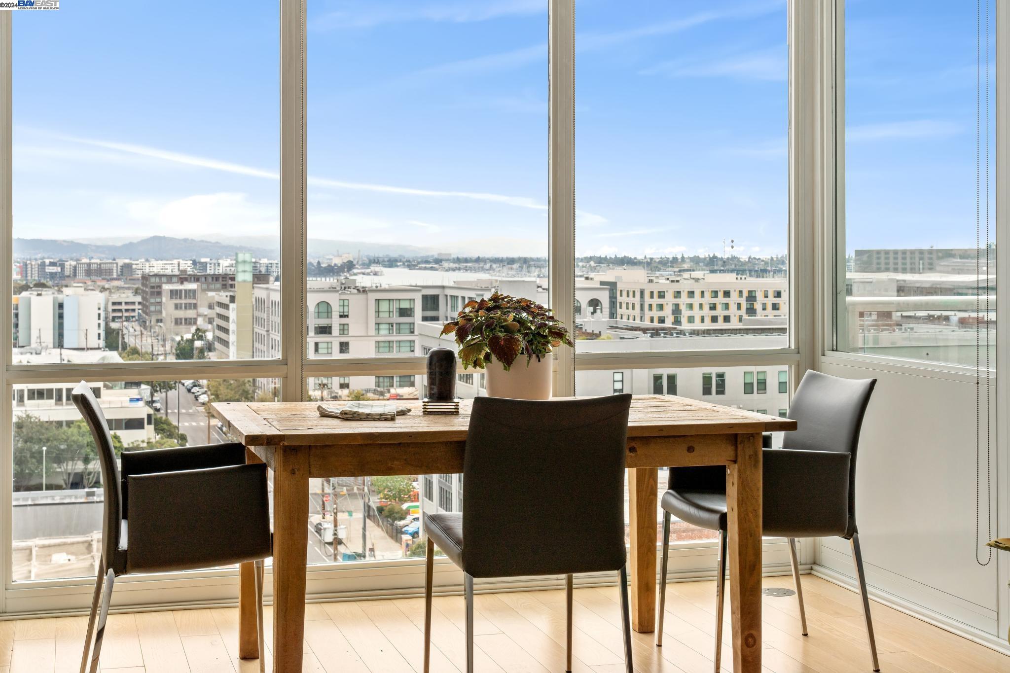 222 Broadway, Unit 1106 Oakland, CA 94607 - Photo 11 of 22 a view of a dining room with furniture large windows and wooden floor