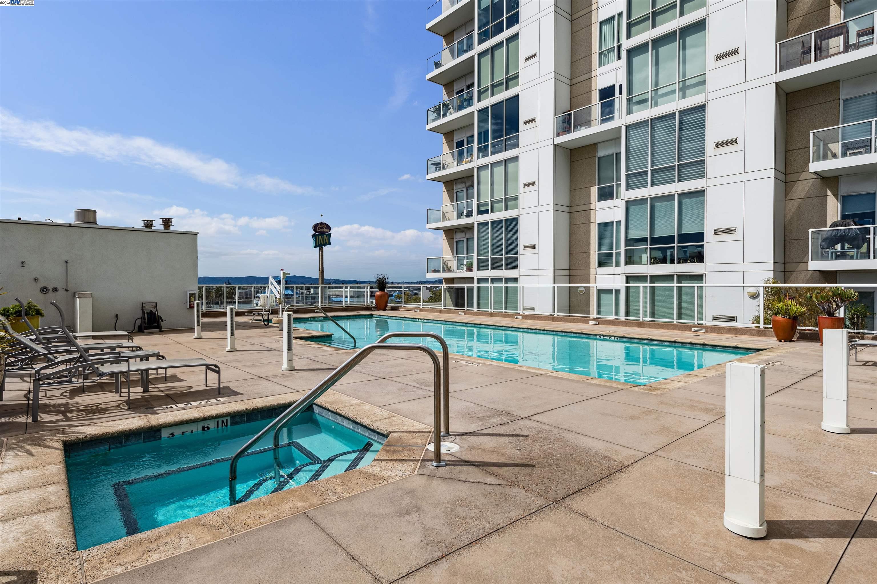 222 Broadway, Unit 1106 Oakland, CA 94607 - Photo 16 of 22 a view of a swimming pool with a lounge chairs