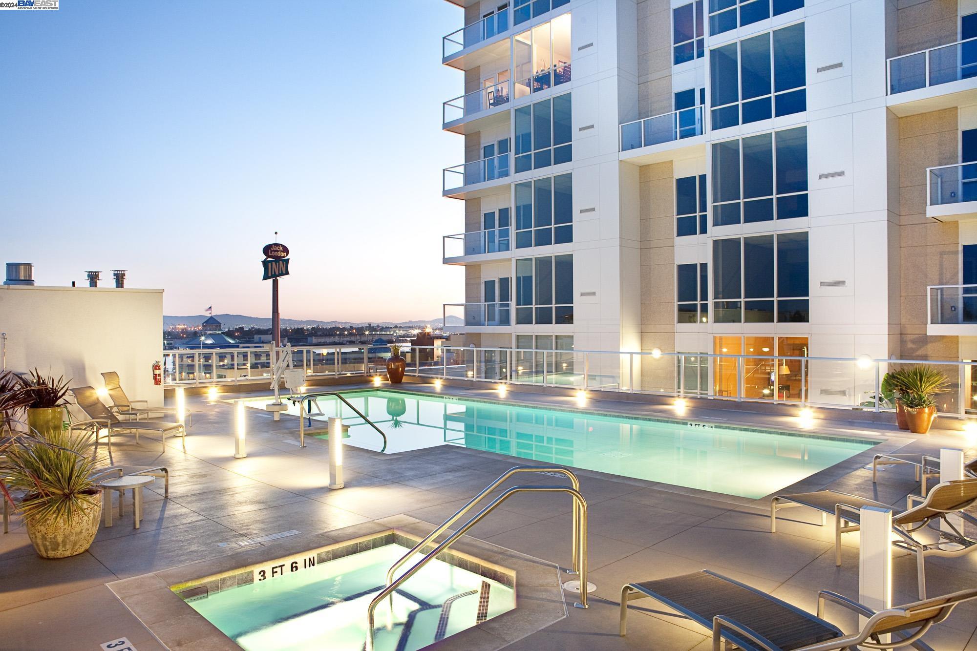 222 Broadway, Unit 1106 Oakland, CA 94607 - Photo 19 of 22 a view of a swimming pool with a lounge chairs