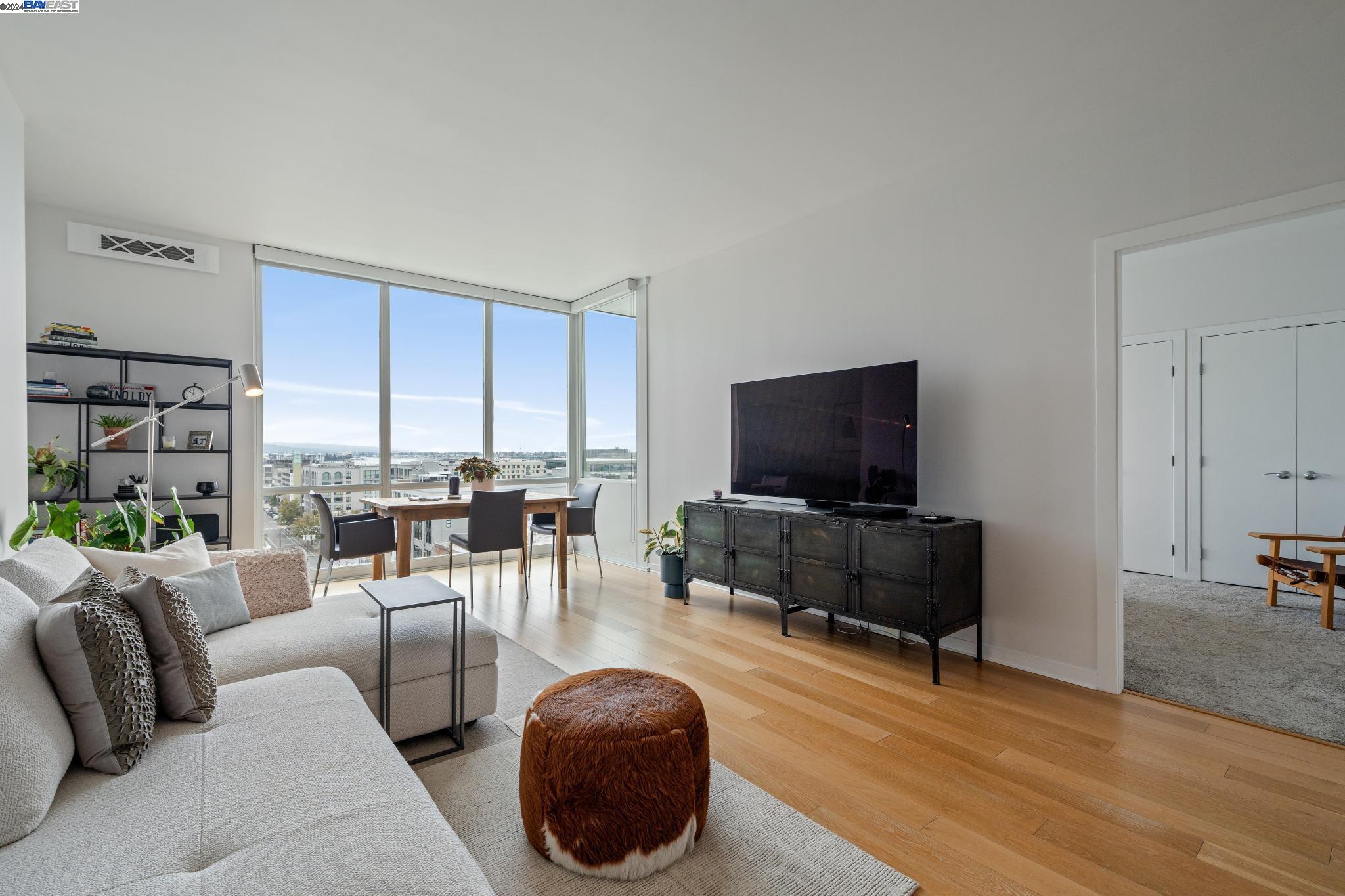 222 Broadway, Unit 1106 Oakland, CA 94607 - Photo 7 of 22 a living room with furniture and a flat screen tv