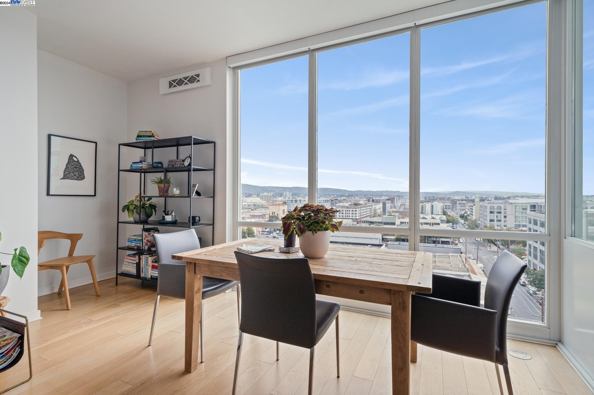 222 Broadway, Unit 1106 Oakland, CA 94607 - Photo 8 of 22 a dining room with furniture and wooden floor