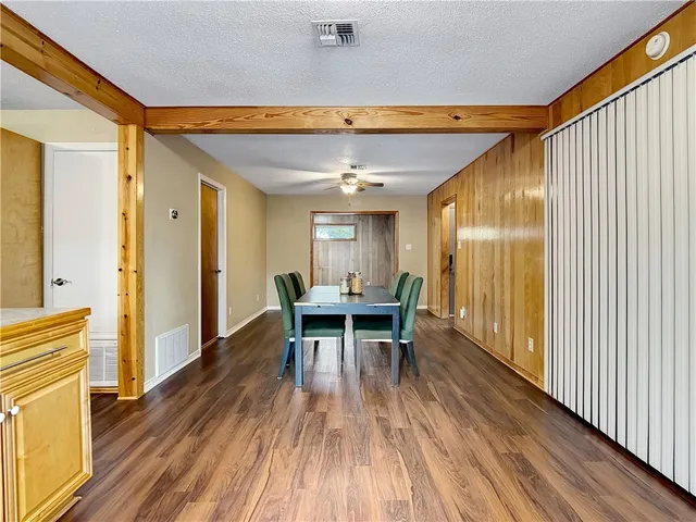 a dining room with furniture and wooden floor