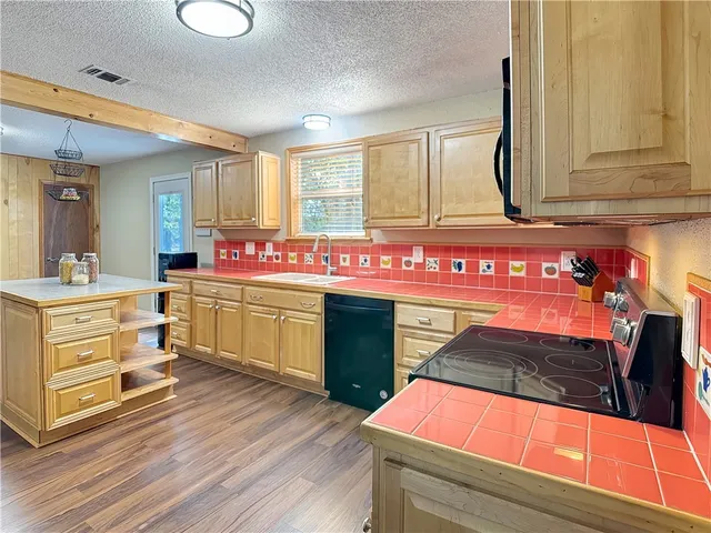 a kitchen with a stove and white cabinets